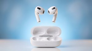 White wireless earbuds floating above an open charging case
